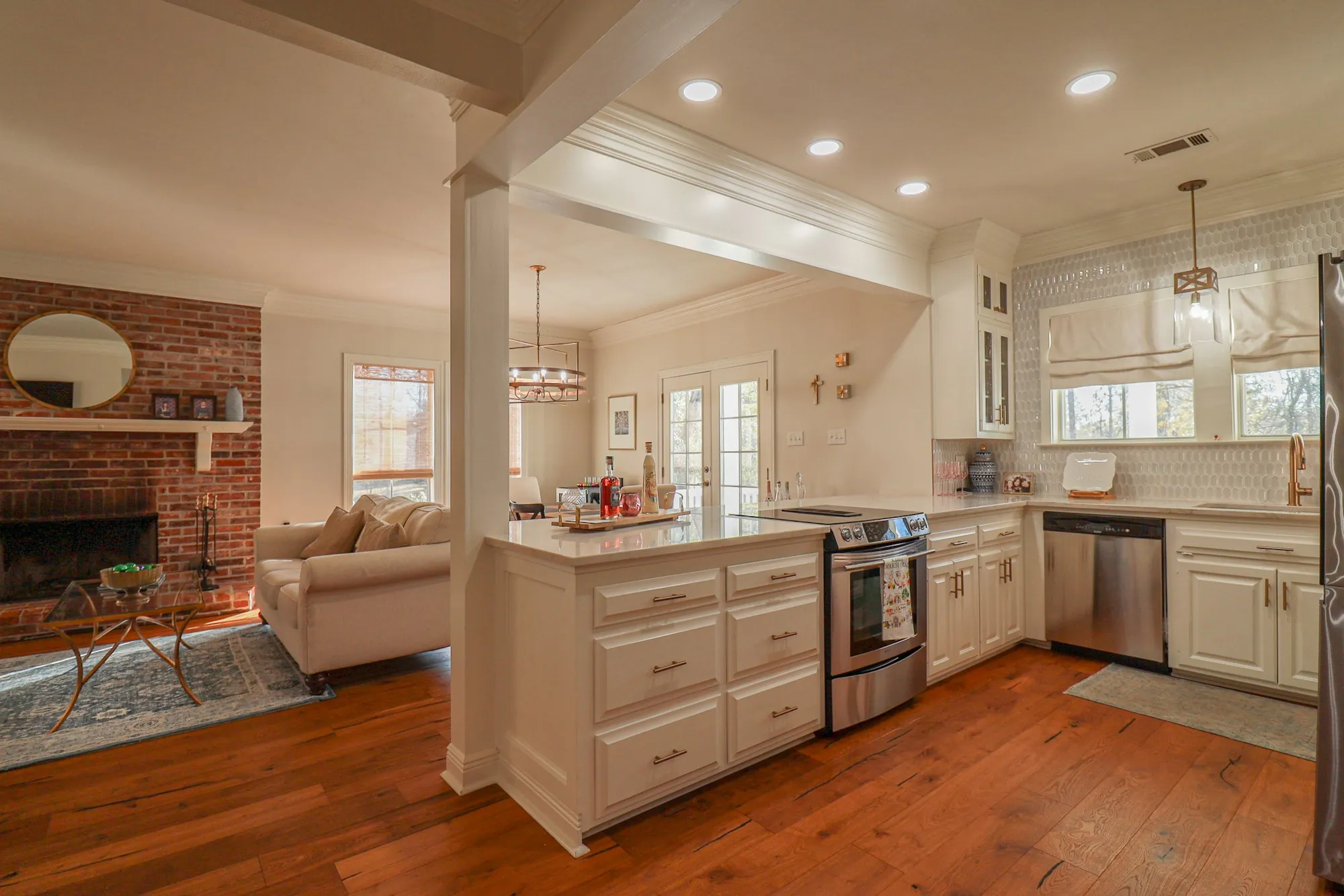 Open living room and kitchen with a brick fireplace